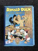 Three volumes Walt Disneys Comics in slip covers and three volumes Donald Duck the Mummies Ring in