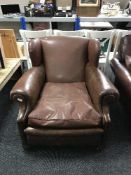 An early 20th century leather club armchair