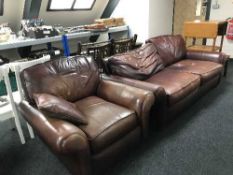 A contemporary brown leather two seater settee and armchair
