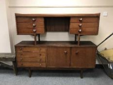 A teak low sideboard and a teak knee hole dressing table