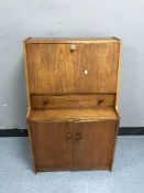 A teak lady's bureau and French style telephone