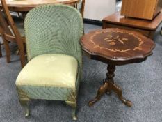 A green Lloyd Loom nursing chair and a pedestal wine table