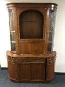 A mahogany bow-fronted bureau display cabinet