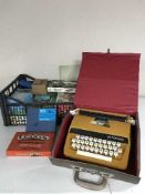 A large quantity of jigsaws, board games, petite typewriter,