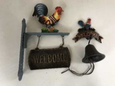 A cast metal Welcome sign together with a cast iron bell