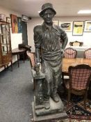 An impressive bronze statue depicting a blacksmith with hammer,