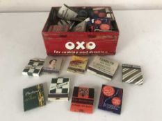 An Oxo tin containing vintage match books