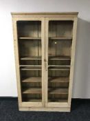 A striped pine glazed door bookcase