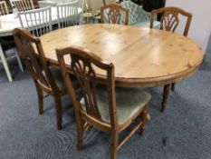 A Ducal Pine extending dining table and four chairs