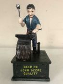 A cast metal John Deere money bank