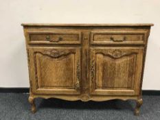 A French oak double-door serving cabinet fitted with two drawers
