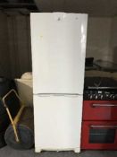 An Indesit upright fridge freezer