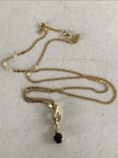 An 18ct gold sapphire set pendant on chain