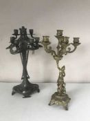 A metal art deco style six way candelabrum together with a brass six way candelabrum depicting a