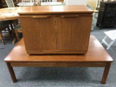 A Danish teak low coffee table and a teak double door TV cabinet