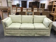 A three seater settee in green classical print