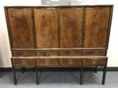 A walnut four door sideboard fitted eight drawers