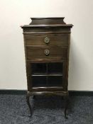 An Edwardian mahogany music cabinet