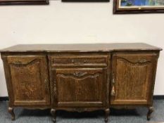A French oak breakfront sideboard