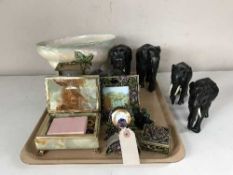 A tray of carved ebony elephant ornaments, desk clock with photo frame, pill box, perfume bottle,