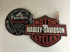 Two cast metal advertising signs - Triumph Bonneville and Harley Davidson cycles