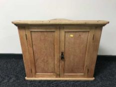 A pine double door hanging corner cabinet