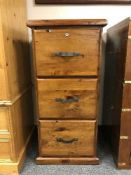 A plantation pine three drawer filing chest and keys