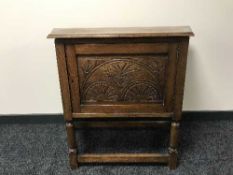 A carved oak shaped cabinet