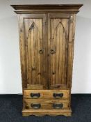 A heavy pine double door wardrobe fitted two drawers