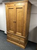 A pine double wardrobe fitted two drawers