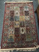 A fringed Persian rug of compartmentalised design 163 cm x 100 cm