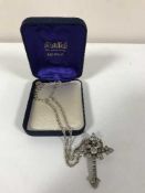 A silver cross on chain