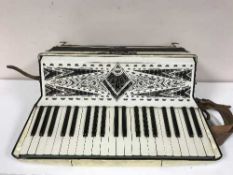 A accordion by Geraldo in a carry bag