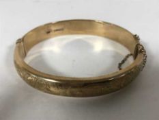A 9ct gold bangle,