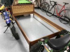A 1970's teak and wicker 4' bed frame
