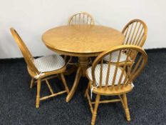 A circular pedestal kitchen table and four chairs