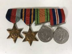 A group of four WWII medals with ribbons inc.