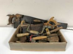 A box of vintage hand saws, braces,
