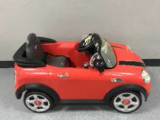 A child's Mini Cooper electric car with charger