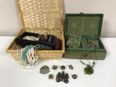 A basket of assorted costume jewellery, badges,