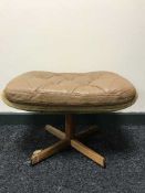 A mid 20th century button leather swivel footstool on a rosewood base