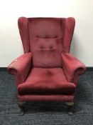 A red buttoned dralon wing backed chair