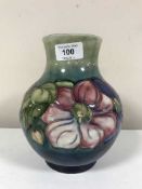 A Moorcroft Clematis vase with blue\green background, height 19cms.