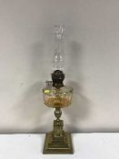 A Victorian glass and brass oil lamp with chimney