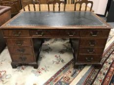 A Victorian mahogany twin pedestal desk with tooled leather top,