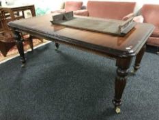 A Victorian style wind out table with leaf