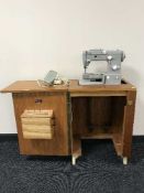 A Pfaff electric sewing machine in teak table