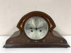 An inlaid mahogany mantel clock with pendulum and key
