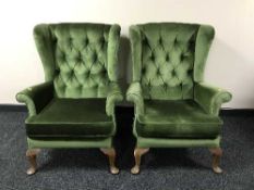 A pair of green buttoned dralon wing backed chairs