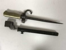 A British Enfield bayonet in sheath and a French spike bayonet